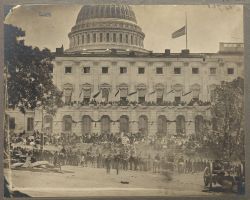 Matthew Brady's photograph of spectators massing for the Grand Review of the Armies, 23-24 May 1865, at the side of the crepe-draped U.S. Capitol, flag at half mast following the assassination of President Abraham Lincoln. (Library of Congress: Public domain.)